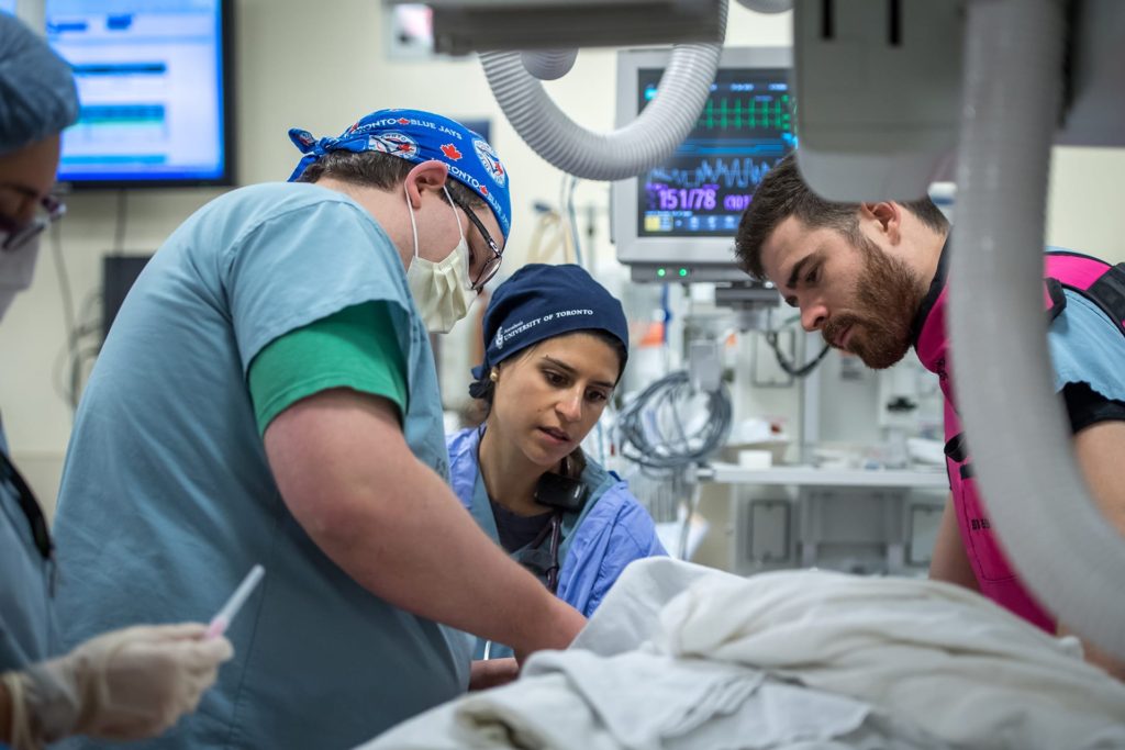 Doctors and nurses working on patient 